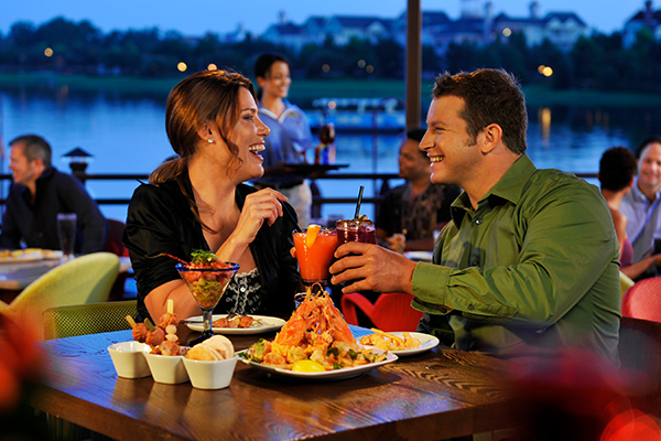 Couple enjoying dinner and drinks at Big River Grill at Disney's Boardwalk