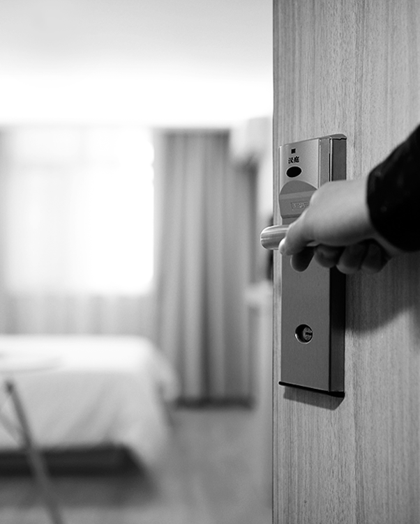 hand opening door into hotel room