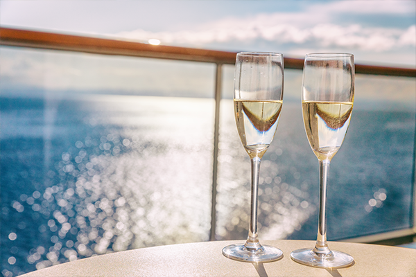 Two champagne flues on overlook ocean on cruise ship