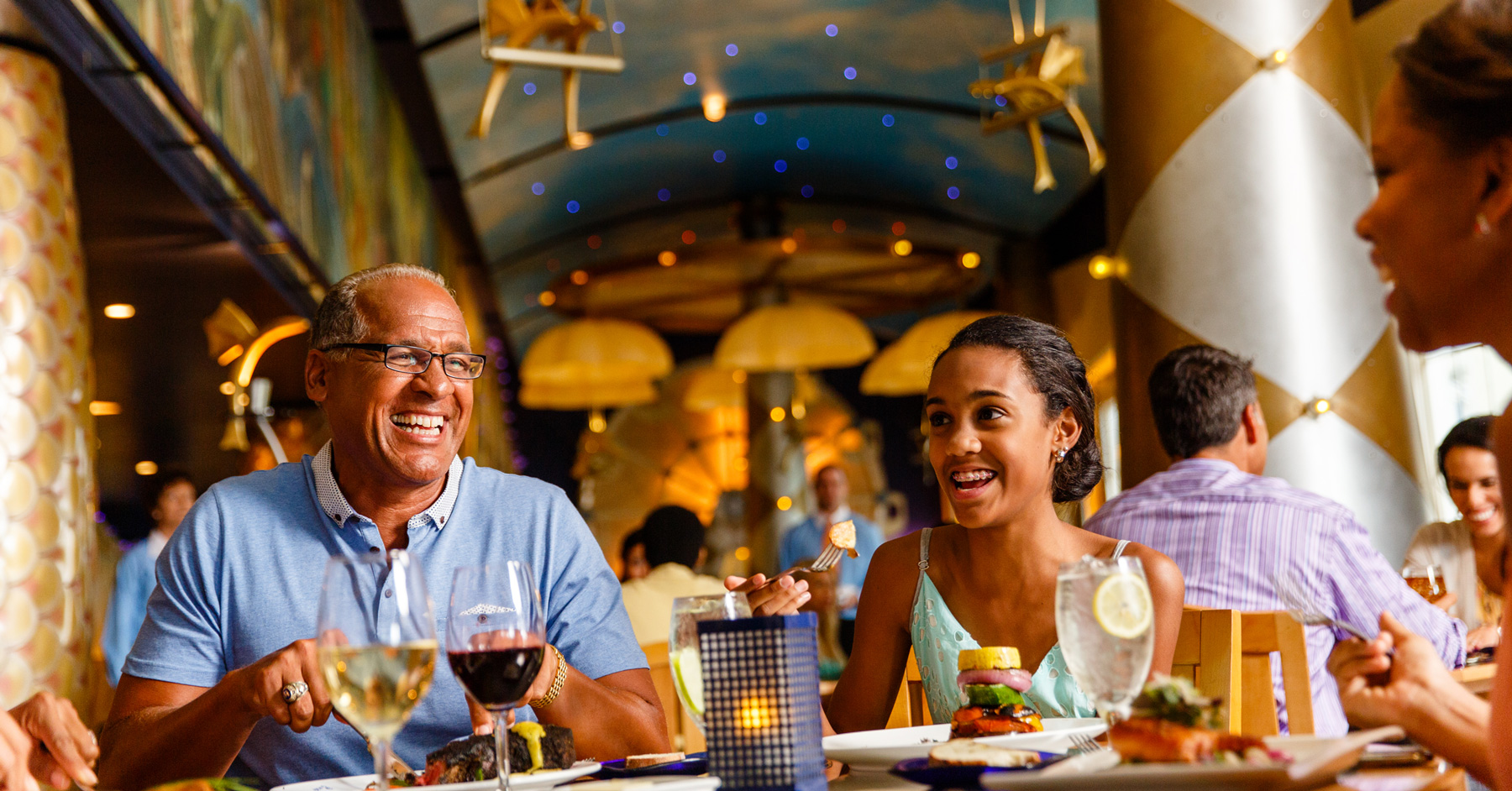Family eating dinner at Disney's Flying Fish restaurant at Disney World Boardwalk Resort