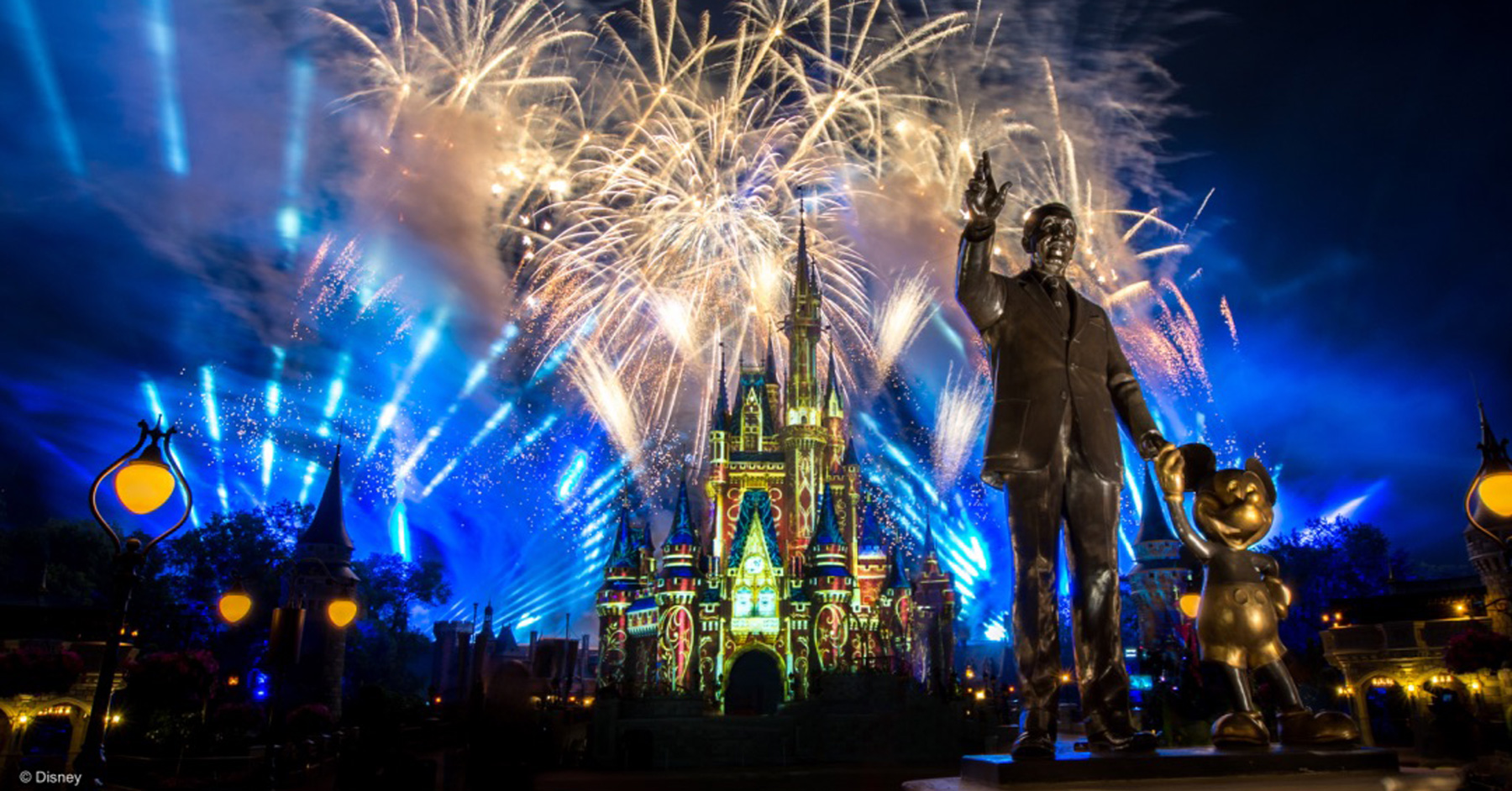 Disney World Magic Kingdom fireworks with Walt Disney and Mickey Mouse statue